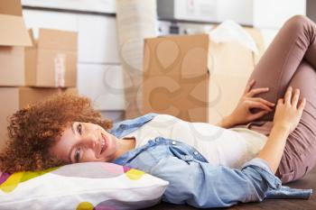 Woman Taking A Break Whilst Moving Into New Home