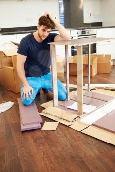 Frustrated Man Putting Together Self Assembly Furniture