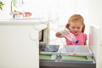 Girl Recycling Kitchen Waste In Bin