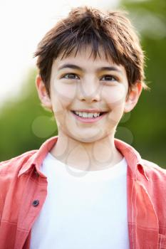 Portrait Of Smiling Hispanic Boy In Countryside