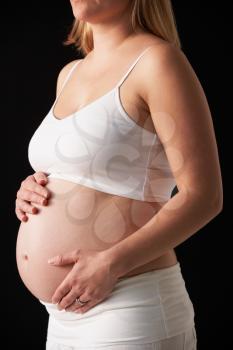 Close Up Portrait Of 5 months Pregnant Woman On Black Background