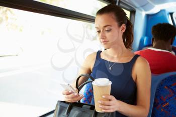 Businesswoman Sending Text Message On Bus