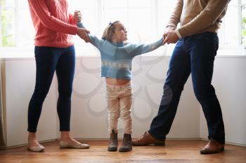 Two Parents Fighting Over Child In Divorce Concept