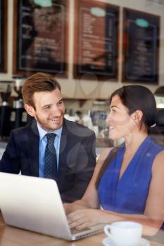 Businessman And Businesswoman Meeting In Coffee Shop