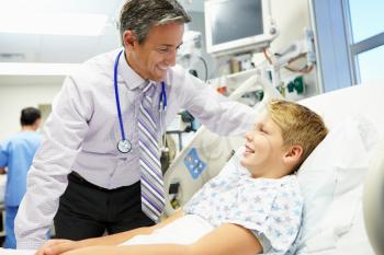 Boy Talking To Male Consultant In Emergency Room