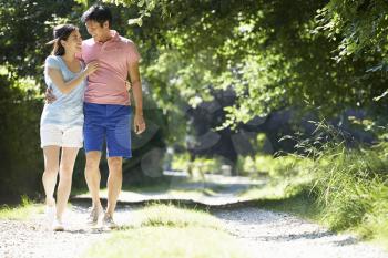 Romantic Asian Couple On Walk In Countryside