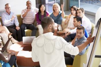 Businessman Making Presentation To Office Colleagues