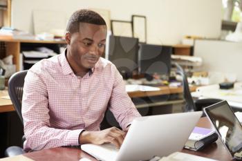 Male Architect Working At Desk On Laptop