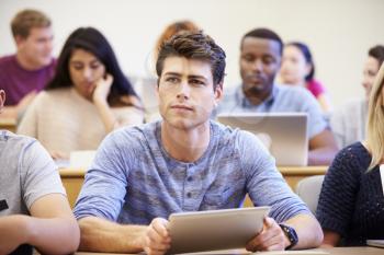 Male University Student Using Digital Tablet In Lecture