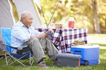 Senior Man On Camping Holiday With Fishing Rod