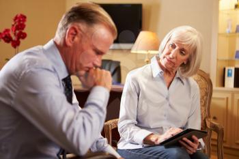 Man Talking To Female Counsellor Using Digital Tablet