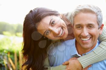 Portrait Of Loving Hispanic Couple In Countryside