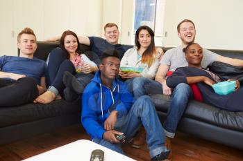 Group Of Friends Watching Television At Home Together