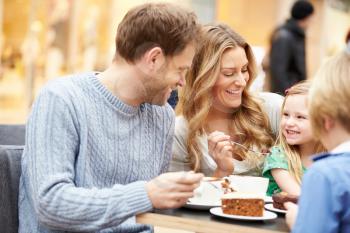 Family Enjoying Snack In Caf Together