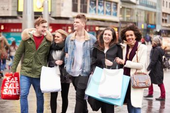 Group Of Young Friends Shopping Outdoors Together