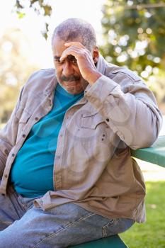 Depressed Senior Man Sitting Outside