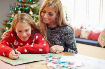 Mother And Daughter Writing Letter To Santa Together