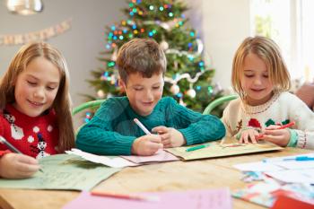 Three Children Writing Letters To Santa Together