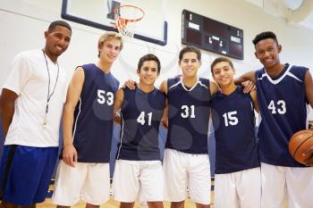 Members Of Male High School Basketball Team With Coach