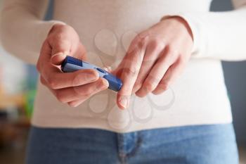 Female Diabetic Checking Blood Sugar Levels