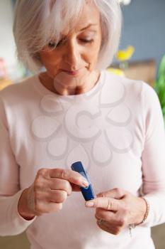 Senior Female Diabetic Checking Blood Sugar Levels
