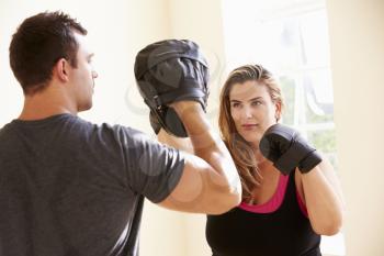 Fitness Instructor Teaching Boxing In Exercise Class