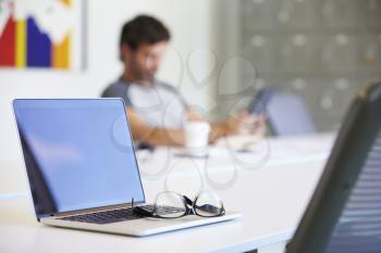 Laptop And Glasses On Desk In Design Studio