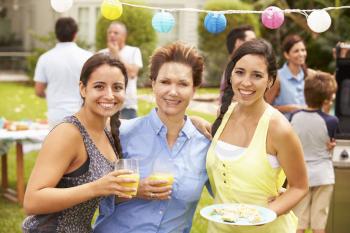 Mother With Adult Daughters Enjoying Party In Garden