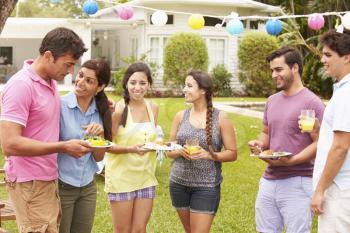 Group Of Friends Having Party In Backyard At Home