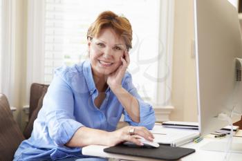 Portrait Of Senior Woman Using Computer At Home