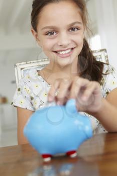 Young girl with piggy bank