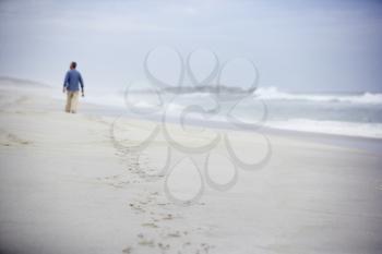 Senior man walking on beach