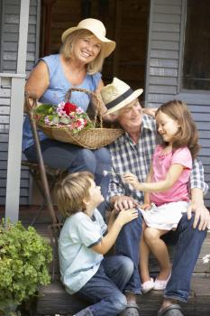 Senior couple on veranda with grandchildren