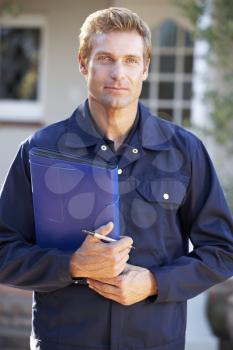 Man in overalls holding folder