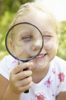 Little girl with magnifying glass