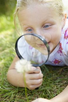 Little girl with magnifying glass