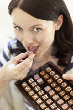 Woman eating chocolates