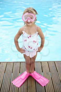 Little girl by outdoor swimming pool