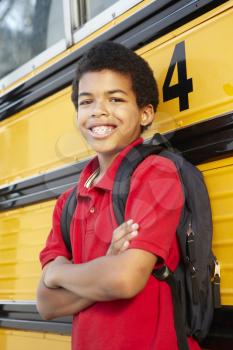 Pre teen boy with school bus