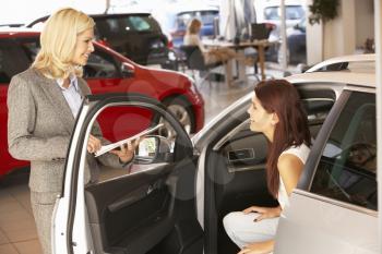 Young woman buying new car