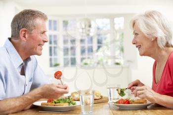Retired couple enjoying meal at home