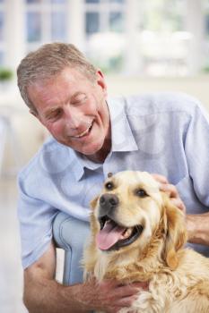 Senior man at home with dog