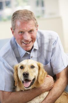 Senior man at home with dog