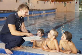 Boys having swimming lesson