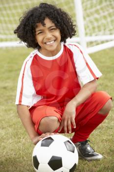 Portrait boy in soccer kit with ball