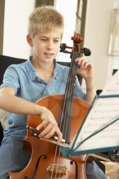 Boy playing cello at home