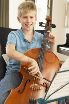 Boy playing cello at home