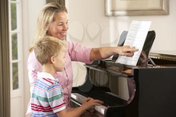 Young boy in lesson with piano teacher