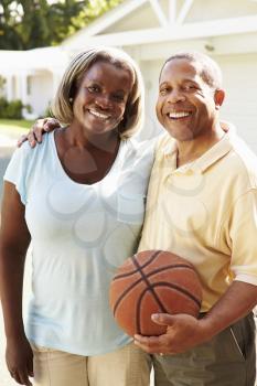 Senior Couple Playing Basketball Together
