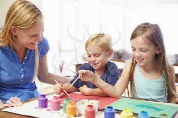 Mother Painting Picture With Children At Home